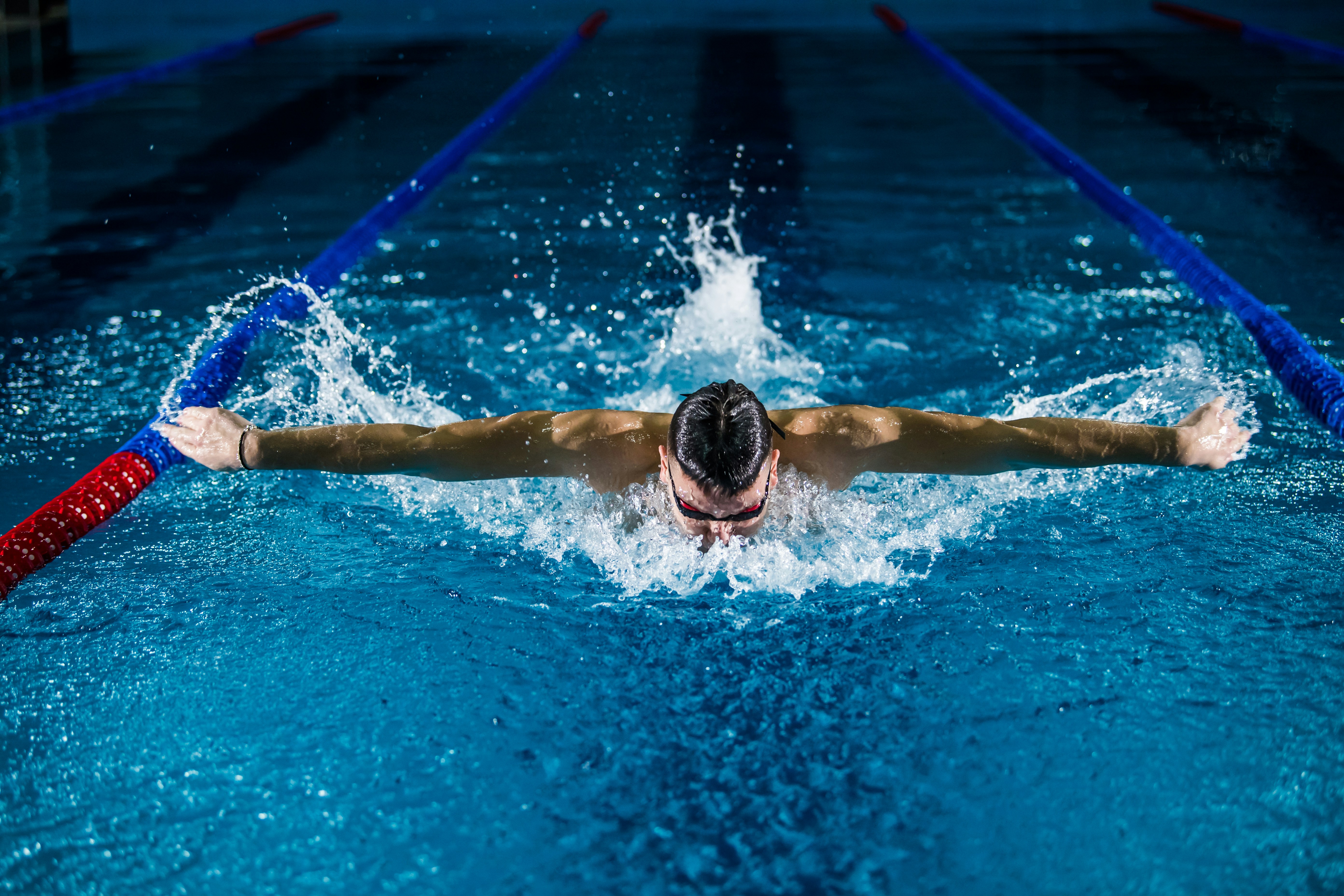 man swimming the butterfly stroke