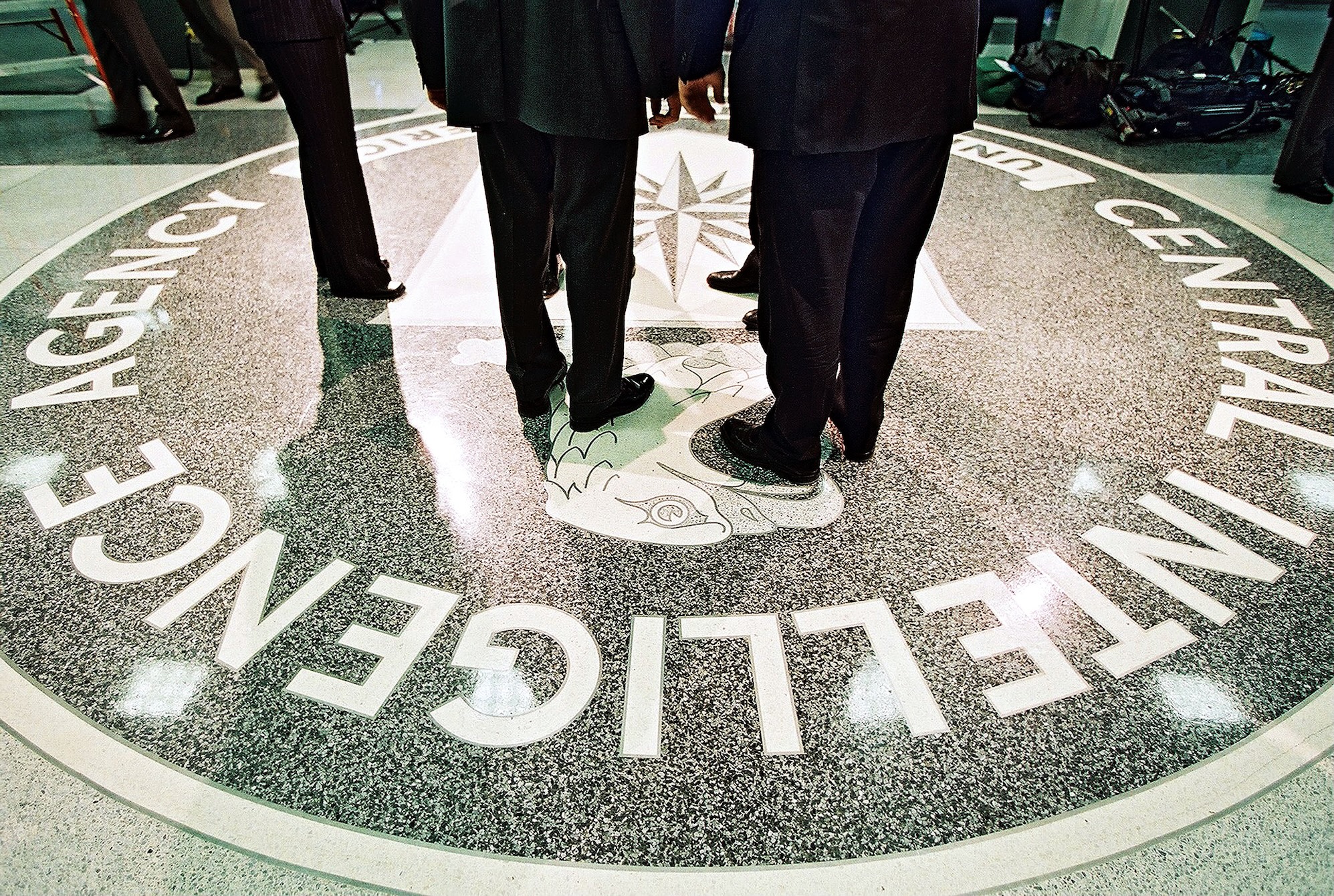 386984 06: President George W. Bush, Central Intelligence Agency Director George Tenet and others stand on the seal of the Agency March 20, 2001 at the CIA Headquarters in Langley, Virginia. Bush toured the facility and met some of the Agency''s employees. (Pool Photo by David Burnett/Newsmakers)