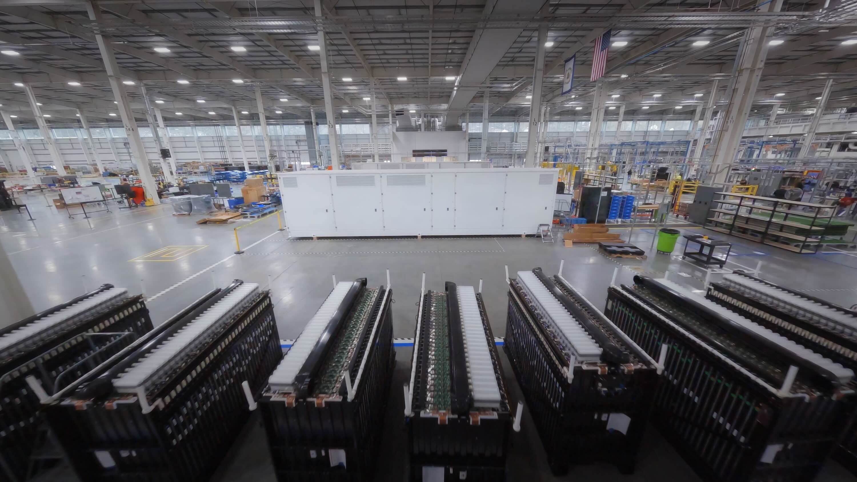 A big battery sits inside a factory.