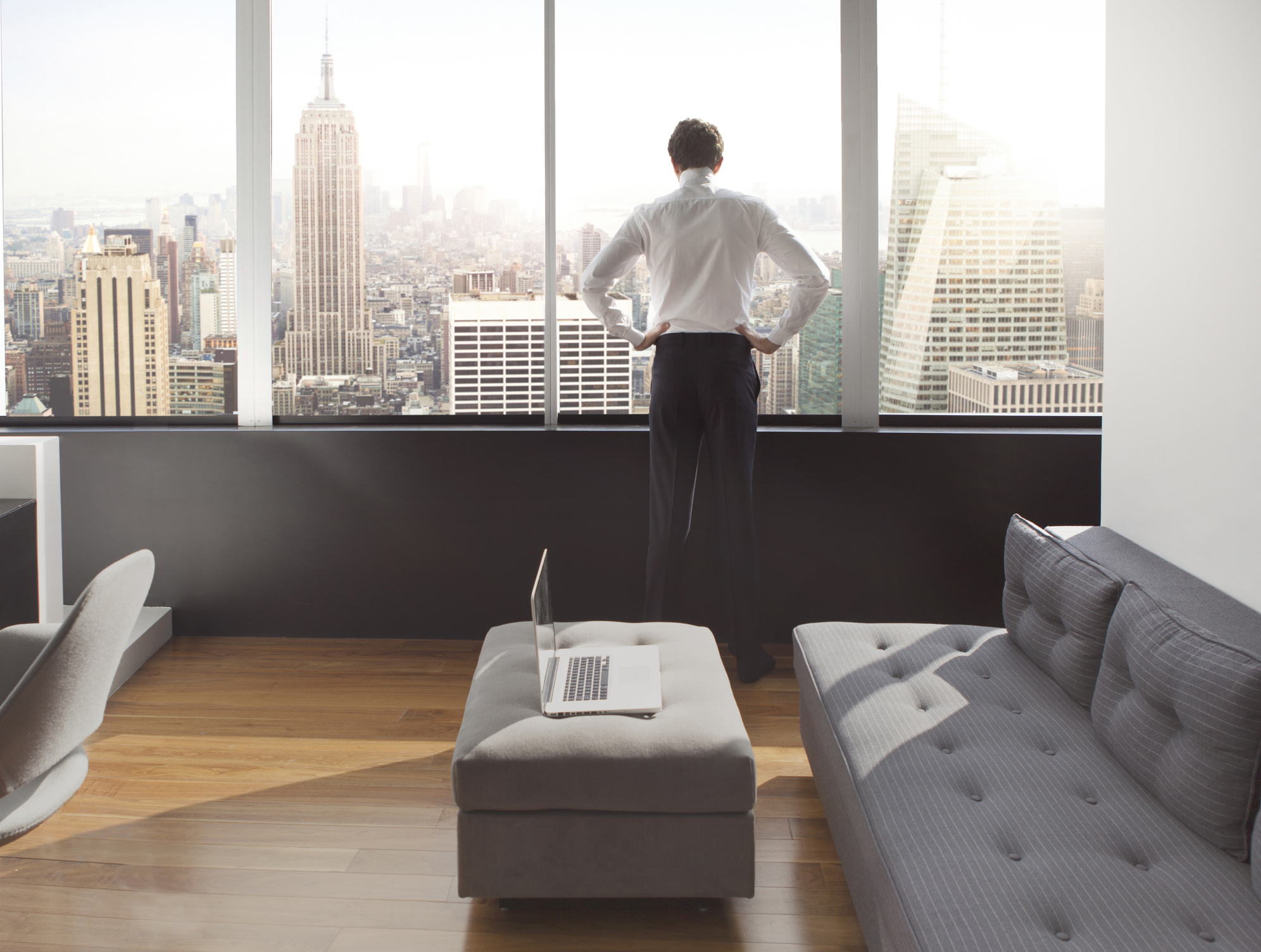 Young man looking out at city skyline.