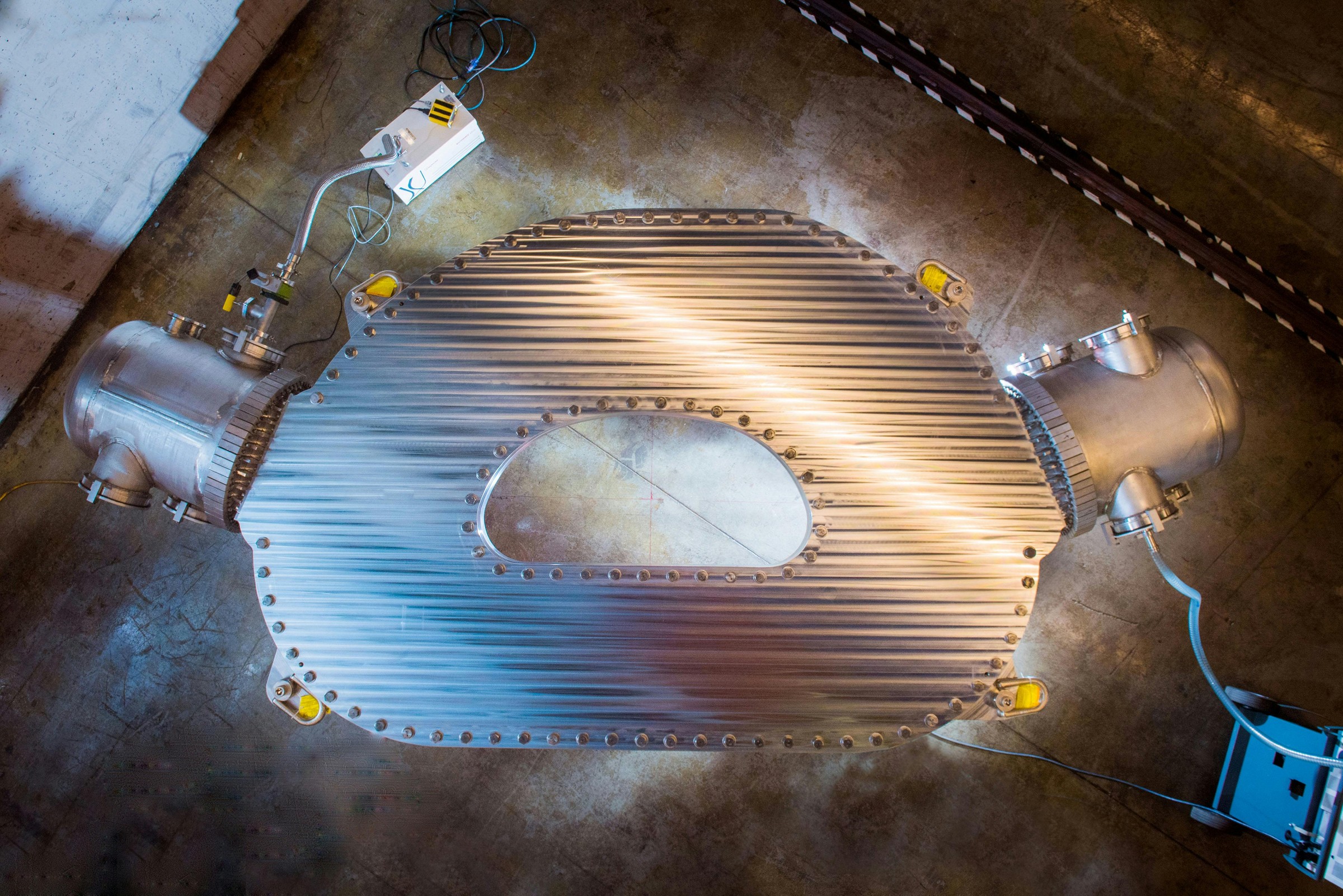 A large HTS magnet sits on the floor of a warehouse.