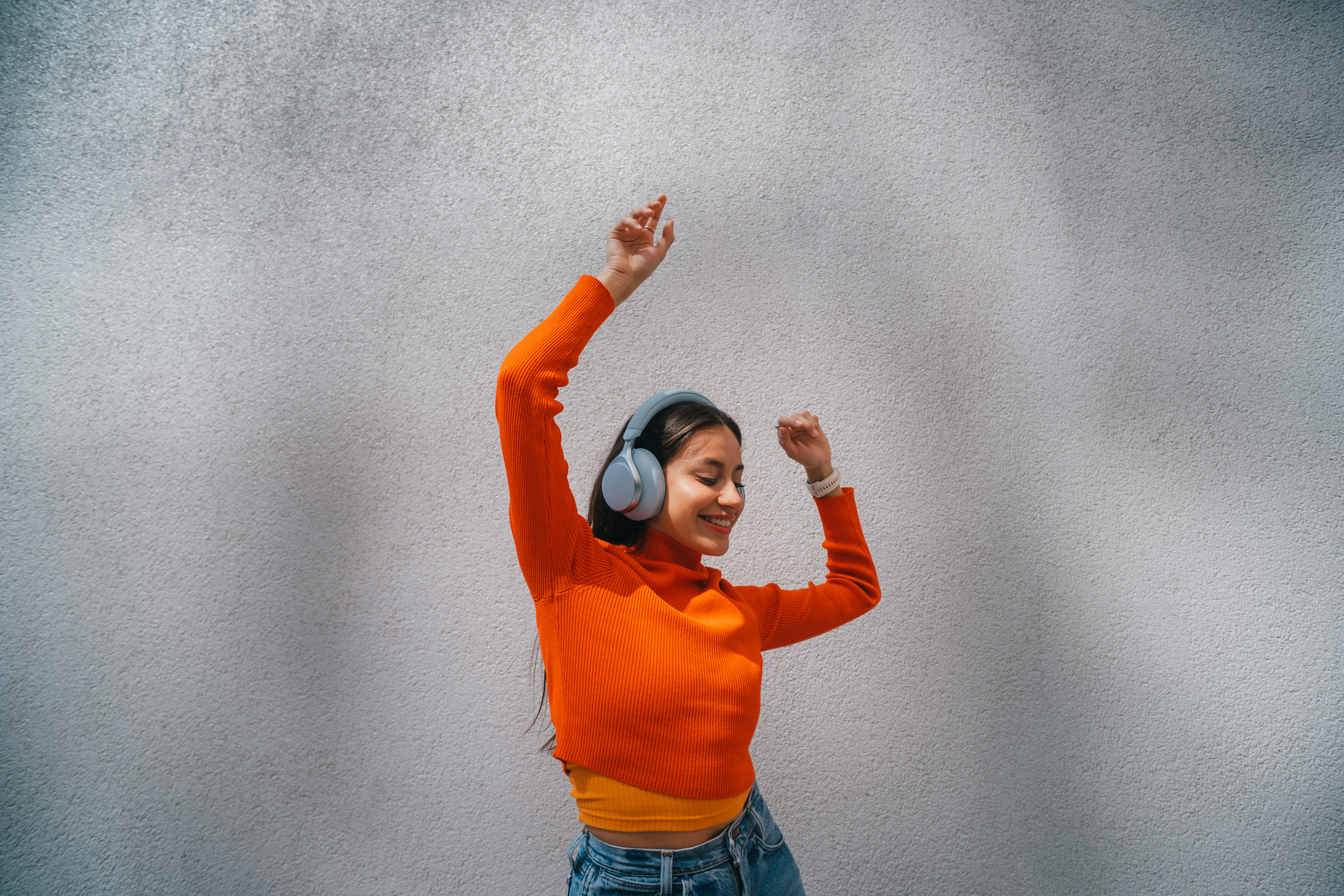 woman dancing wearing headphones