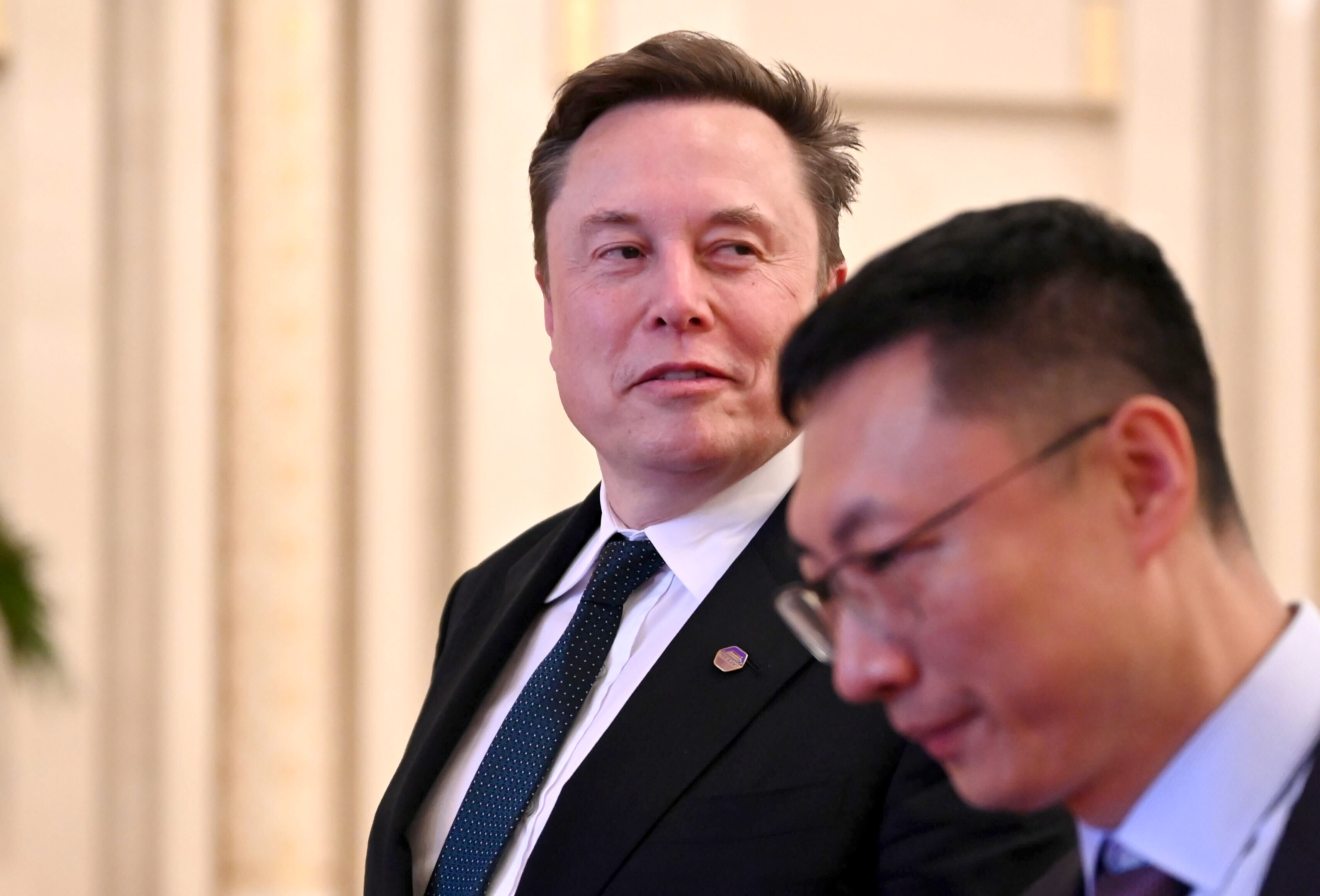 Tech billionaire and Tesla founder Elon Musk walks through the Great Hall of the People.