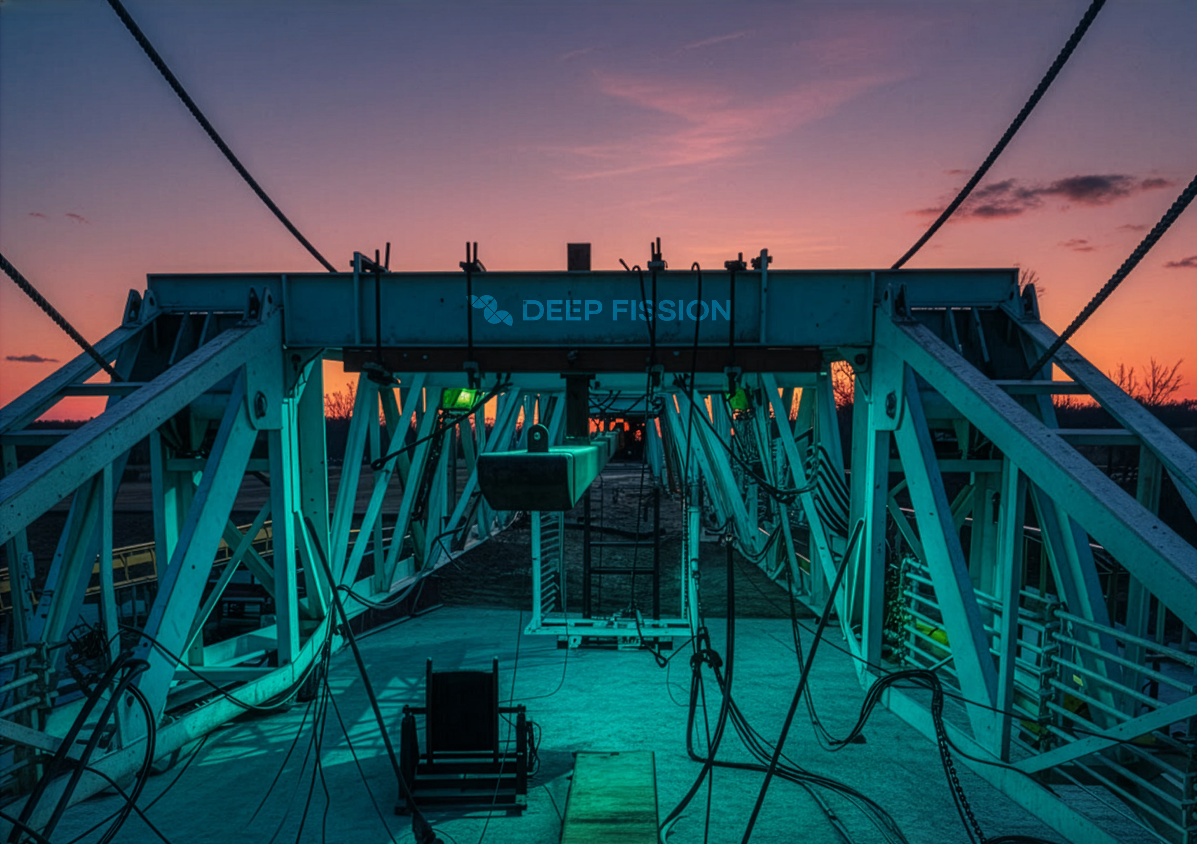 A drilling rig stands in front of a sunset.