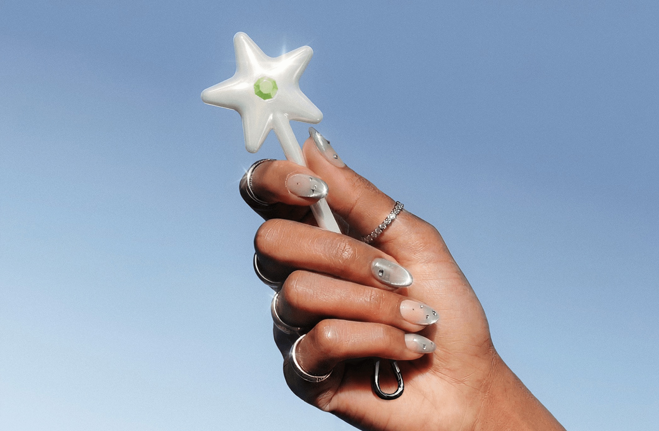hand holding a star-tipped wand