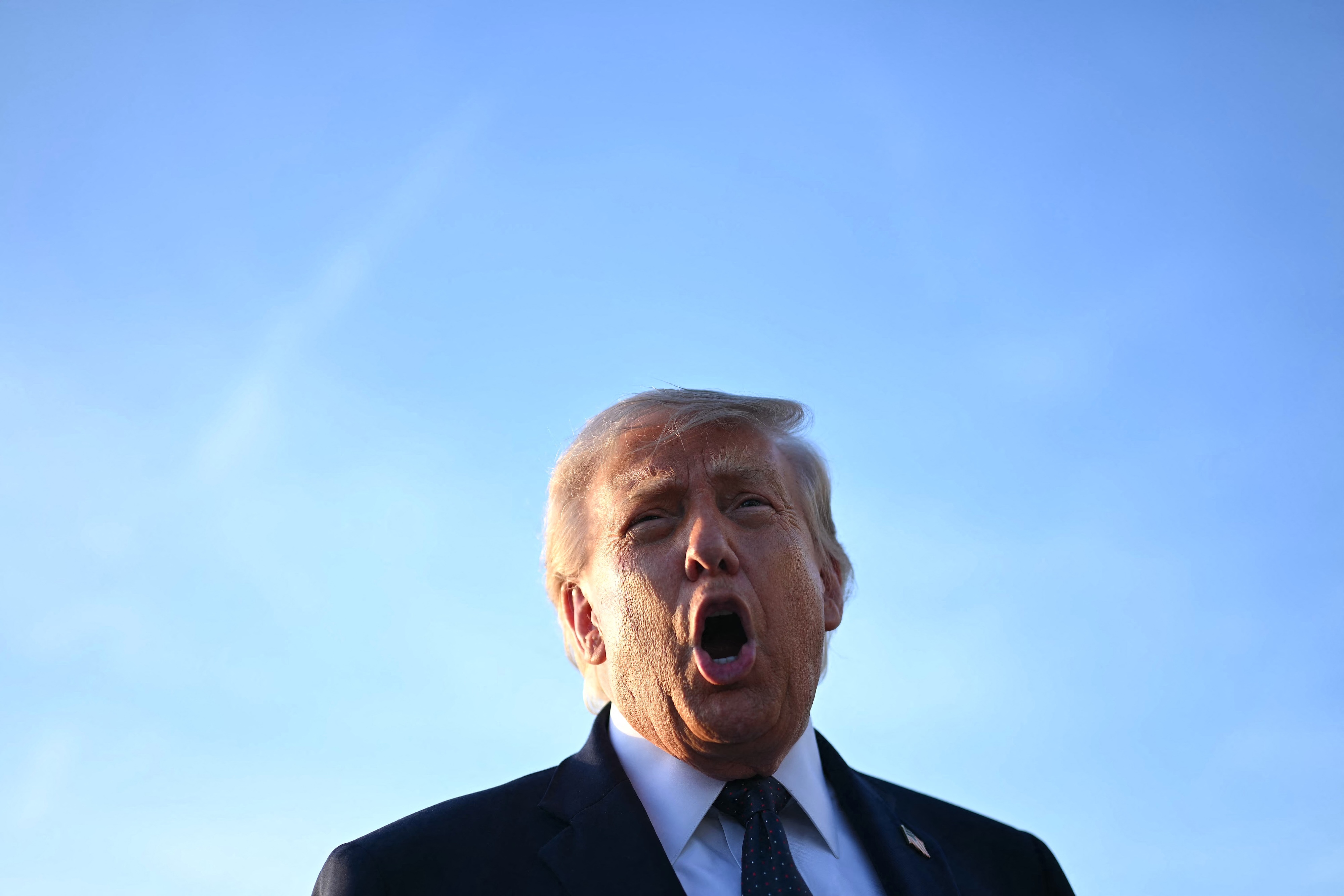 US President Donald Trump addresses the media on the tarmac after arriving at Paris Orly Airport.