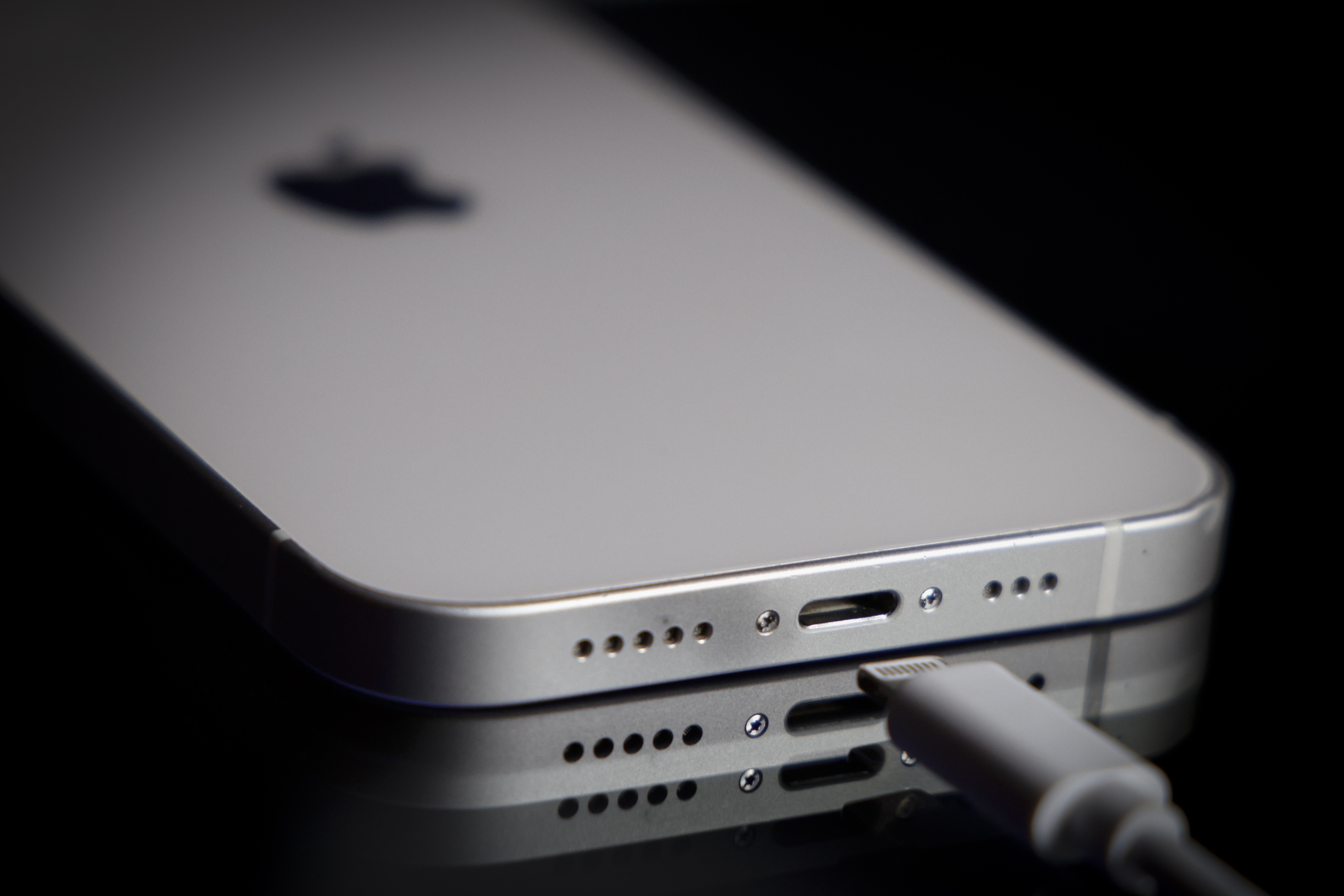 A Apple Lightning port charging cable is seen with with an iPhone.