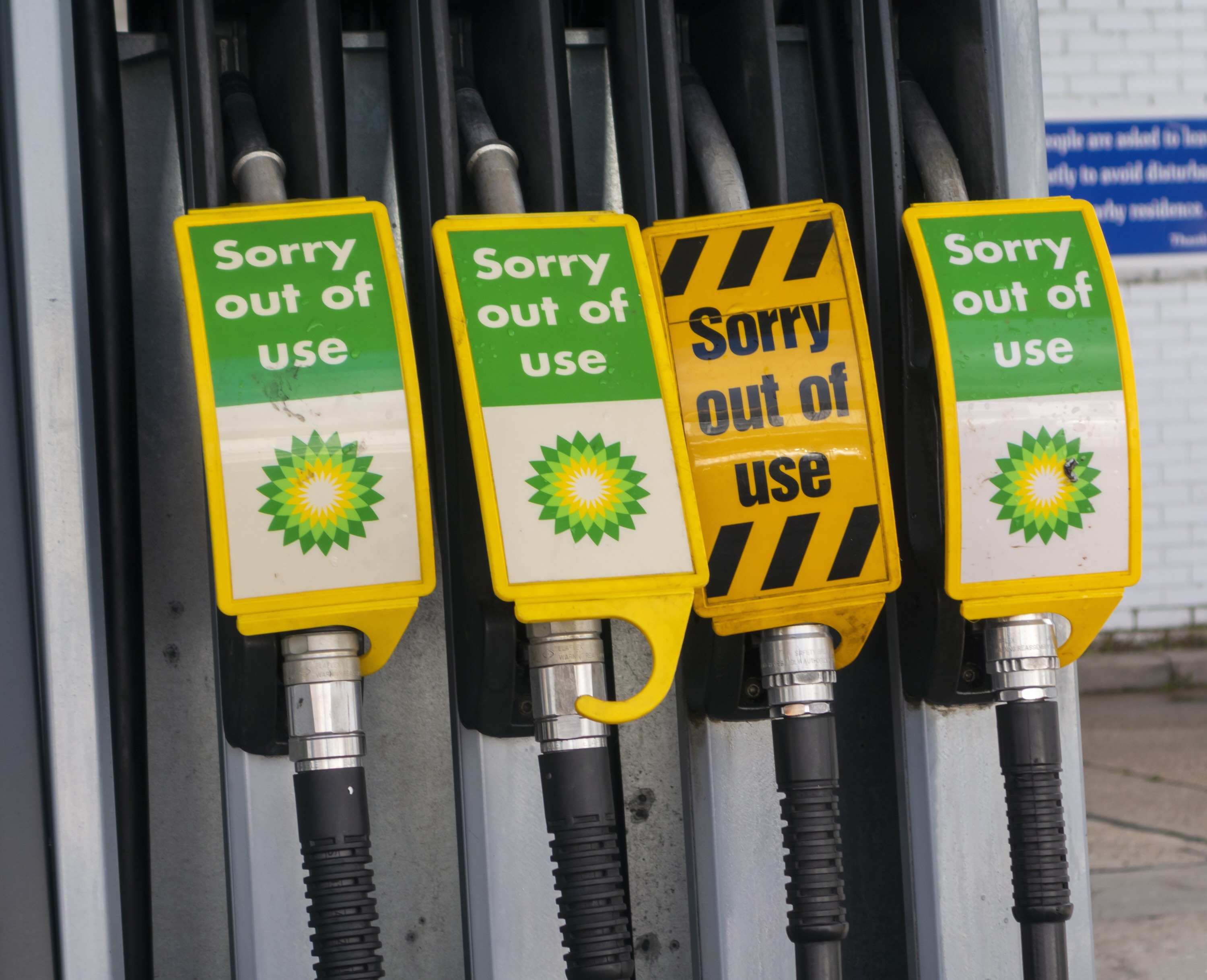 Signs warn drivers that gas pumps are out of order.
